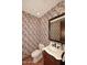 This half bathroom has beautiful wallpaper, custom vanity, and ceramic tile flooring at 2041 W Hemlock Way, Chandler, AZ 85248