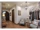 Inviting hallway featuring elegant tile flooring, chandelier, and charming decorative accents at 2041 W Hemlock Way, Chandler, AZ 85248