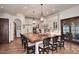 Bright kitchen featuring a large island with chairs, white cabinetry, and stainless-steel appliances at 2041 W Hemlock Way, Chandler, AZ 85248