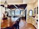 Inviting living room features wood beam ceilings, diamond pattern tile floors, and a large arched window at 2041 W Hemlock Way, Chandler, AZ 85248