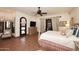 This main bedroom has a ceiling fan, custom furniture and french doors to the yard at 2041 W Hemlock Way, Chandler, AZ 85248