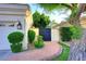 Charming side yard featuring manicured bushes, decorative pavers, and a secure gate at 2041 W Hemlock Way, Chandler, AZ 85248