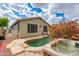 Relaxing backyard with in-ground pool, spa, and string lights at 20713 N 91St Dr, Peoria, AZ 85382