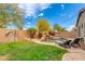 Lush backyard with pool, waterfall feature, tropical landscaping, and stone patio at 20713 N 91St Dr, Peoria, AZ 85382