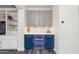 Bar area boasts gray and blue cabinets, quartz countertop and wine refrigerator at 20713 N 91St Dr, Peoria, AZ 85382