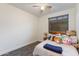Cozy bedroom featuring a ceiling fan, one window, and plush decor at 20713 N 91St Dr, Peoria, AZ 85382