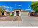 Charming home with a two-car garage and desert landscaping under a bright blue sky at 20713 N 91St Dr, Peoria, AZ 85382