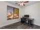 Bright home office with ceiling fan, desk, and window with a view at 20713 N 91St Dr, Peoria, AZ 85382