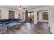 Spacious living room with a sectional sofa, hardwood floors, and natural light at 20713 N 91St Dr, Peoria, AZ 85382