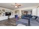 Large living room with TV, built-ins and open floor plan to kitchen and bar area at 20713 N 91St Dr, Peoria, AZ 85382
