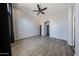 Spacious bedroom featuring sleek wood-look floors, a modern ceiling fan, and ample natural light at 20802 N 7Th Pl, Phoenix, AZ 85024