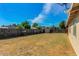 The backyard features a large grassy area, a wooden fence and a storage shed at 2213 E Campbell Ave, Phoenix, AZ 85016
