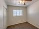 This is a cozy bedroom with neutral walls and carpet, featuring a window and ceiling fan at 2213 E Campbell Ave, Phoenix, AZ 85016