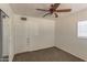 Cozy bedroom featuring neutral walls, carpet, a window, closet, and ceiling fan at 2213 E Campbell Ave, Phoenix, AZ 85016