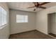 Cozy bedroom with neutral walls, carpet, a window, closet with sliding doors, and ceiling fan at 2213 E Campbell Ave, Phoenix, AZ 85016