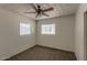 A cozy bedroom featuring neutral walls, carpet, and a window, complemented by a ceiling fan at 2213 E Campbell Ave, Phoenix, AZ 85016