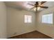 This is a cozy bedroom with neutral walls and carpet, featuring two windows and a ceiling fan at 2213 E Campbell Ave, Phoenix, AZ 85016