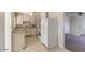 Compact kitchen includes tile floor, white appliances, white cabinets and ample counterspace at 2213 E Campbell Ave, Phoenix, AZ 85016