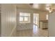 Bright kitchen has tiled floor, white appliances, and a view into a room with large windows at 2213 E Campbell Ave, Phoenix, AZ 85016