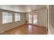 Bright living room with wood floors and access to the backyard through glass doors at 2213 E Campbell Ave, Phoenix, AZ 85016