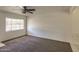Bright living room featuring neutral carpet, a window for natural light, and baseboard trim at 2213 E Campbell Ave, Phoenix, AZ 85016