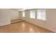 Spacious room featuring wood floors and three large windows at 2213 E Campbell Ave, Phoenix, AZ 85016