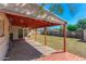 Covered patio has concrete floor, wood roof, and string lights to a grassy backyard at 2213 E Campbell Ave, Phoenix, AZ 85016