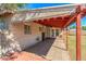 Covered patio with red painted support beams and ceiling, featuring a mix of concrete and painted wood at 2213 E Campbell Ave, Phoenix, AZ 85016