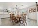 Bright dining room with a wooden table, chandelier lighting, and sliding door access at 2321 N 30Th St, Phoenix, AZ 85008