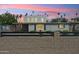 Charming single-Gathering home with a block fence and manicured front yard, set against a vibrant sunset sky at 2321 N 30Th St, Phoenix, AZ 85008