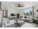 Bright and airy living room with a large window, comfortable seating, and stylish ceiling fan at 2321 N 30Th St, Phoenix, AZ 85008