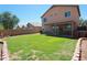 Spacious backyard features a green lawn and covered patio, great for outdoor entertaining at 2434 E San Manuel Rd, San Tan Valley, AZ 85143
