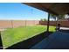 Large backyard featuring a well-maintained lawn, privacy fence, and covered patio at 2434 E San Manuel Rd, San Tan Valley, AZ 85143