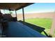 View of backyard with covered patio, green lawn and tall brick fence at 2434 E San Manuel Rd, San Tan Valley, AZ 85143