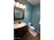 This bathroom has an updated vanity with a sink, a toilet and a unique mirror with custom lighting at 2434 E San Manuel Rd, San Tan Valley, AZ 85143