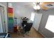 This bedroom has gray walls, a ceiling fan, and a small desk with storage near the wall at 2434 E San Manuel Rd, San Tan Valley, AZ 85143