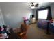 Bedroom featuring gray walls and carpeted floors with furniture and a ceiling fan for optimal comfort at 2434 E San Manuel Rd, San Tan Valley, AZ 85143