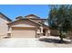 Two-story home featuring a two-car garage, desert landscaping, and a tile roof at 2434 E San Manuel Rd, San Tan Valley, AZ 85143