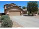 Two-story home featuring a two-car garage, low maintenance desert landscaping, and a tile roof at 2434 E San Manuel Rd, San Tan Valley, AZ 85143