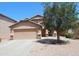 Two-story home featuring a two-car garage, desert landscaping, and a shade tree at 2434 E San Manuel Rd, San Tan Valley, AZ 85143