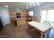 Bright kitchen features a large island, oak cabinets, a dining area, and sliding glass doors to the back yard at 2434 E San Manuel Rd, San Tan Valley, AZ 85143