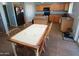 This open kitchen has a dining table and chairs, a kitchen island, and views to the outdoors at 2434 E San Manuel Rd, San Tan Valley, AZ 85143