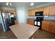Bright kitchen features a large island, stainless steel appliances, and honey-toned wood cabinetry at 2434 E San Manuel Rd, San Tan Valley, AZ 85143