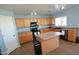 Well-lit kitchen featuring wood cabinets, laminate countertops, and a black appliance package at 2434 E San Manuel Rd, San Tan Valley, AZ 85143