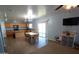 Open floor plan featuring a kitchen and living area with tile floors and modern furnishings at 2434 E San Manuel Rd, San Tan Valley, AZ 85143