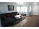 Comfortable living room featuring a sectional sofa, neutral walls, and tile and vinyl flooring at 2434 E San Manuel Rd, San Tan Valley, AZ 85143