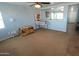 Spacious living room with neutral carpet, ceiling fan, and adjacent tile flooring at 2434 E San Manuel Rd, San Tan Valley, AZ 85143