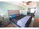 Spacious main bedroom with ceiling fan, carpet, ensuite bathroom, natural light, and neutral walls at 2434 E San Manuel Rd, San Tan Valley, AZ 85143