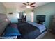 This spacious main bedroom includes carpet, ceiling fan, ensuite bathroom, neutral walls, and a closet at 2434 E San Manuel Rd, San Tan Valley, AZ 85143