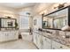 Luxurious bathroom with granite countertops, dual sinks, soaking tub, and elegant fixtures at 27953 N 111Th Way, Scottsdale, AZ 85262